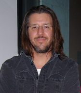"David Foster Wallace headshot 2006" by derivative work: Pabouk (talk)The_best_people_you_will_ever_know.jpg: claudia sherman - The_best_people_you_will_ever_know.jpg. Licensed under CC BY-SA 3.0 via Wikimedia Commons - https://commons.wikimedia.org/wiki/File:David_Foster_Wallace_headshot_2006.jpg#/media/File:David_Foster_Wallace_headshot_2006.jpg