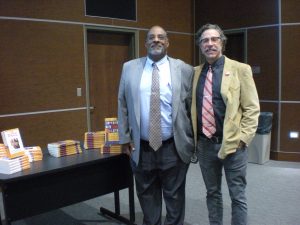 Joseph Graves and Christopher Lynn (author) next to Joe's books, for sale at the ALLELE lecture. Photo by Avery McNeece, 11/10/16.