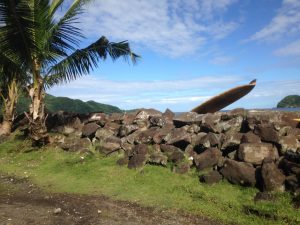 A surf board peeking over a wall near the village of Lauli'i, American Samoa, July 2016.