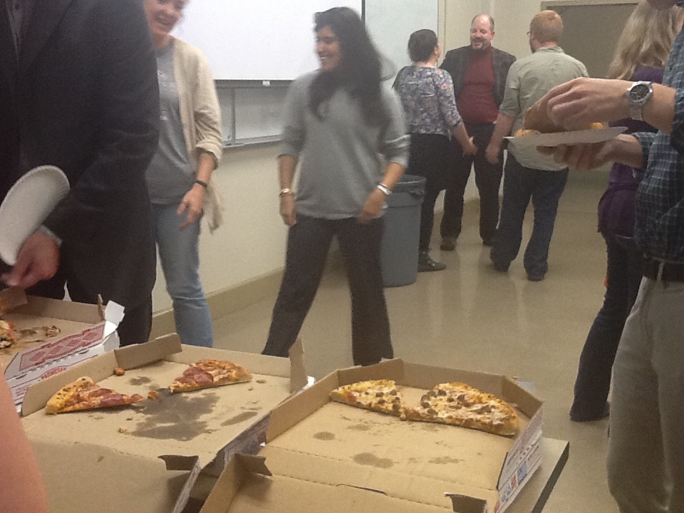 Dr. Hawks talks with students over pizza & cake